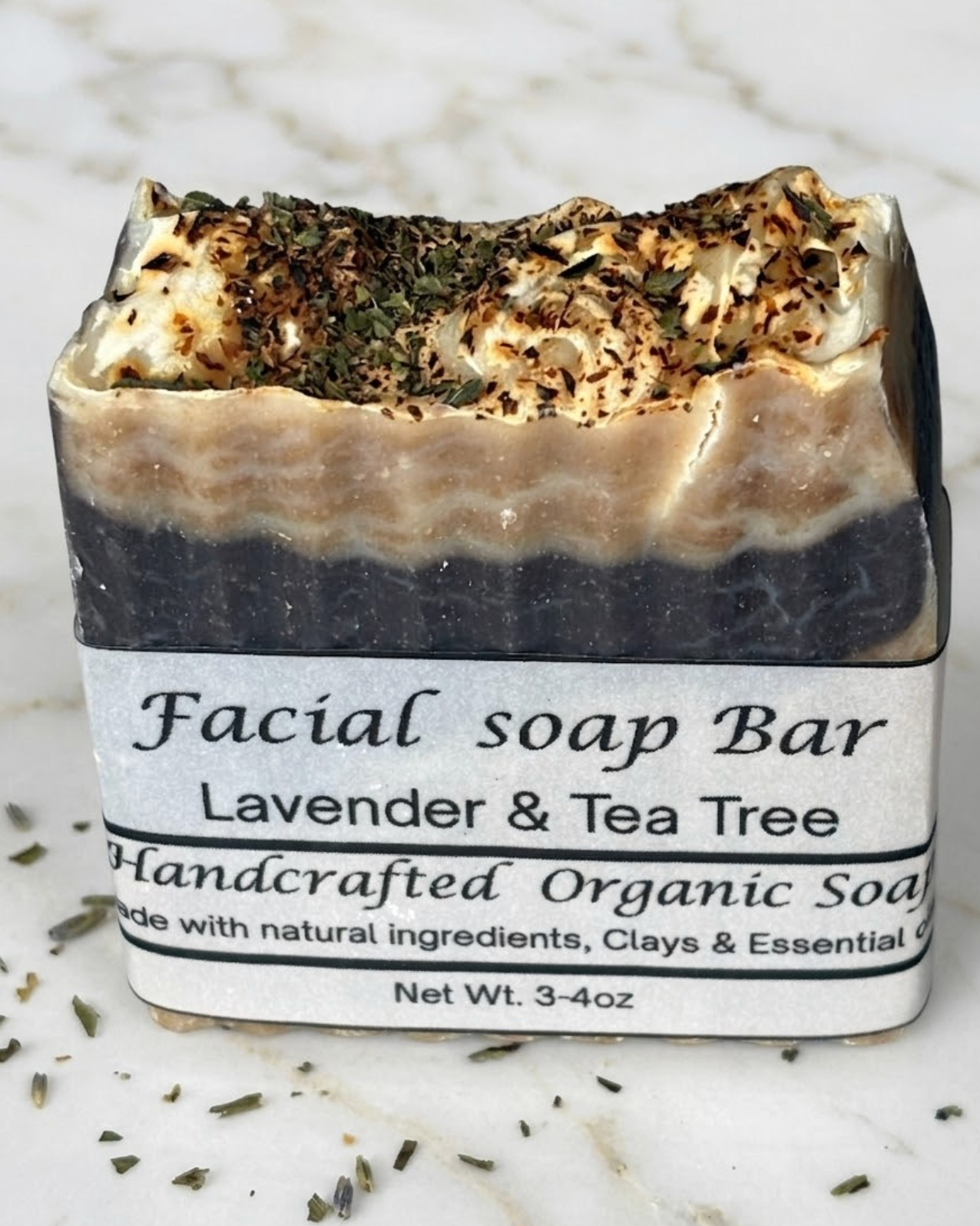 Facial soap bar with lavender and tea tree scent on a marble background