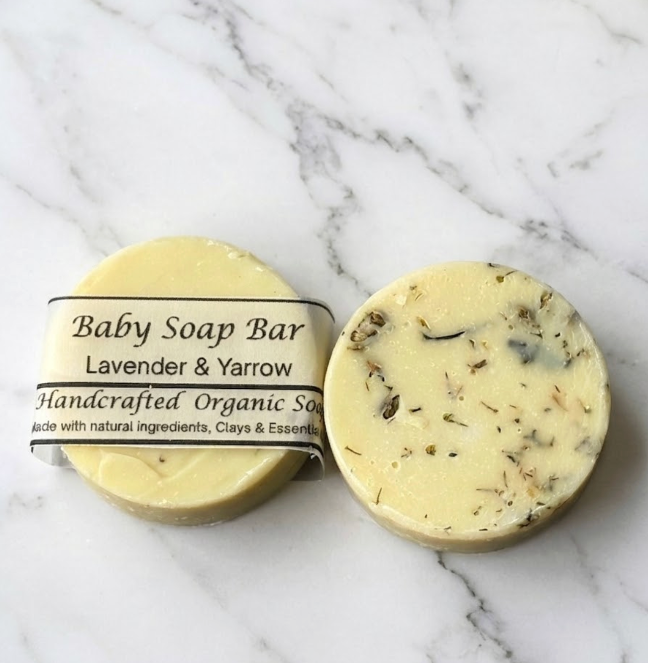 Baby soap bar with lavender and yarrow on a marble background
