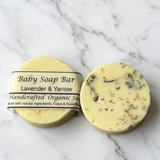 Baby soap bar with lavender and yarrow on a marble background
