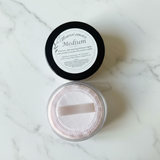 Mineral powder container on a marble surface